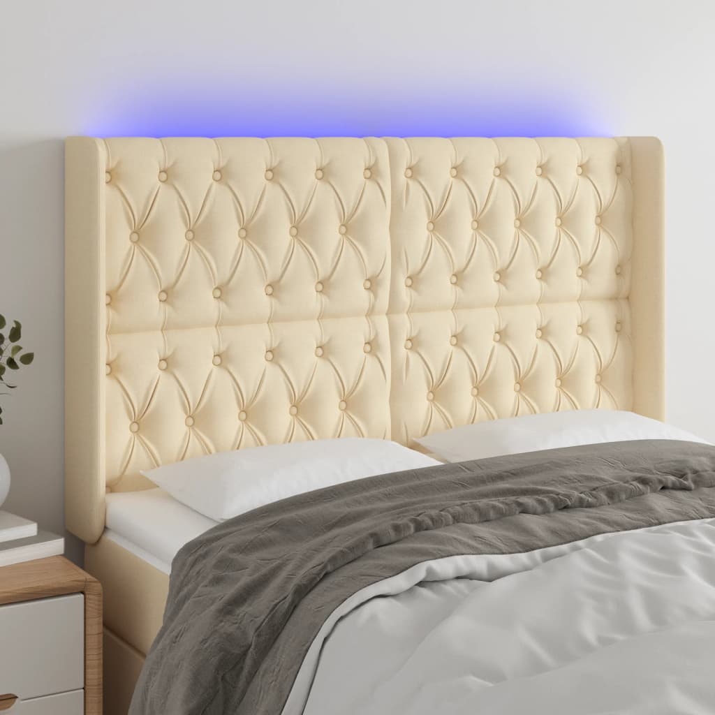 sengegavl med LED-lys 163x16x118/128 cm stof cremefarvet