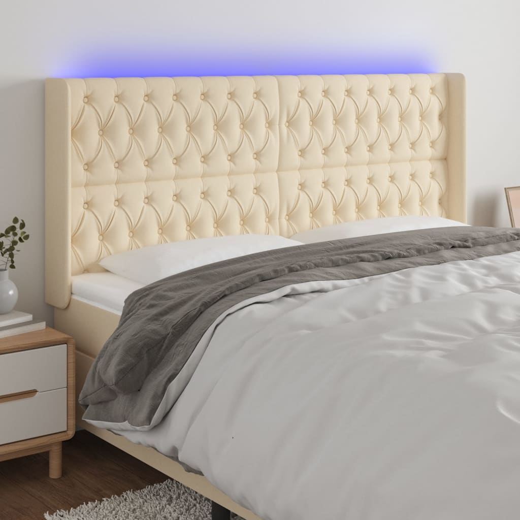 sengegavl med LED-lys 183x16x118/128 cm stof cremefarvet