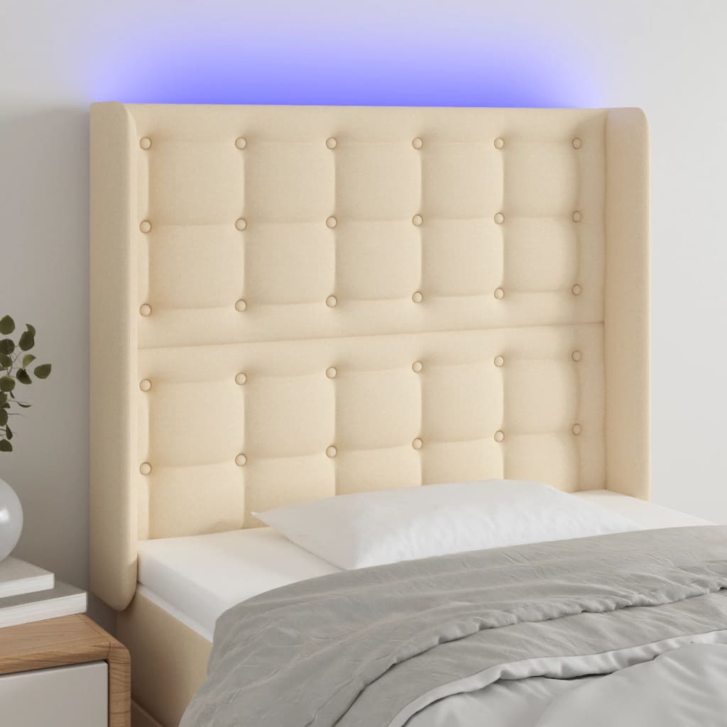 sengegavl med LED-lys 103x16x118/128 cm stof cremefarvet