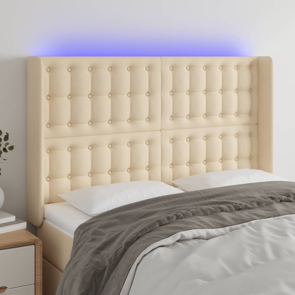 sengegavl med LED-lys 147x16x118/128 cm stof cremefarvet