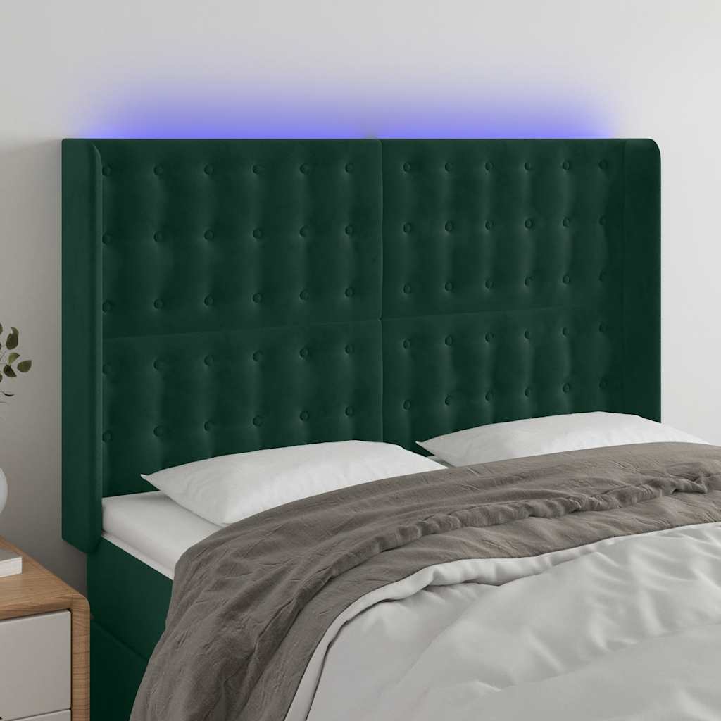 sengegavl med LED-lys 147x16x118/128 cm fløjl mørkegrøn