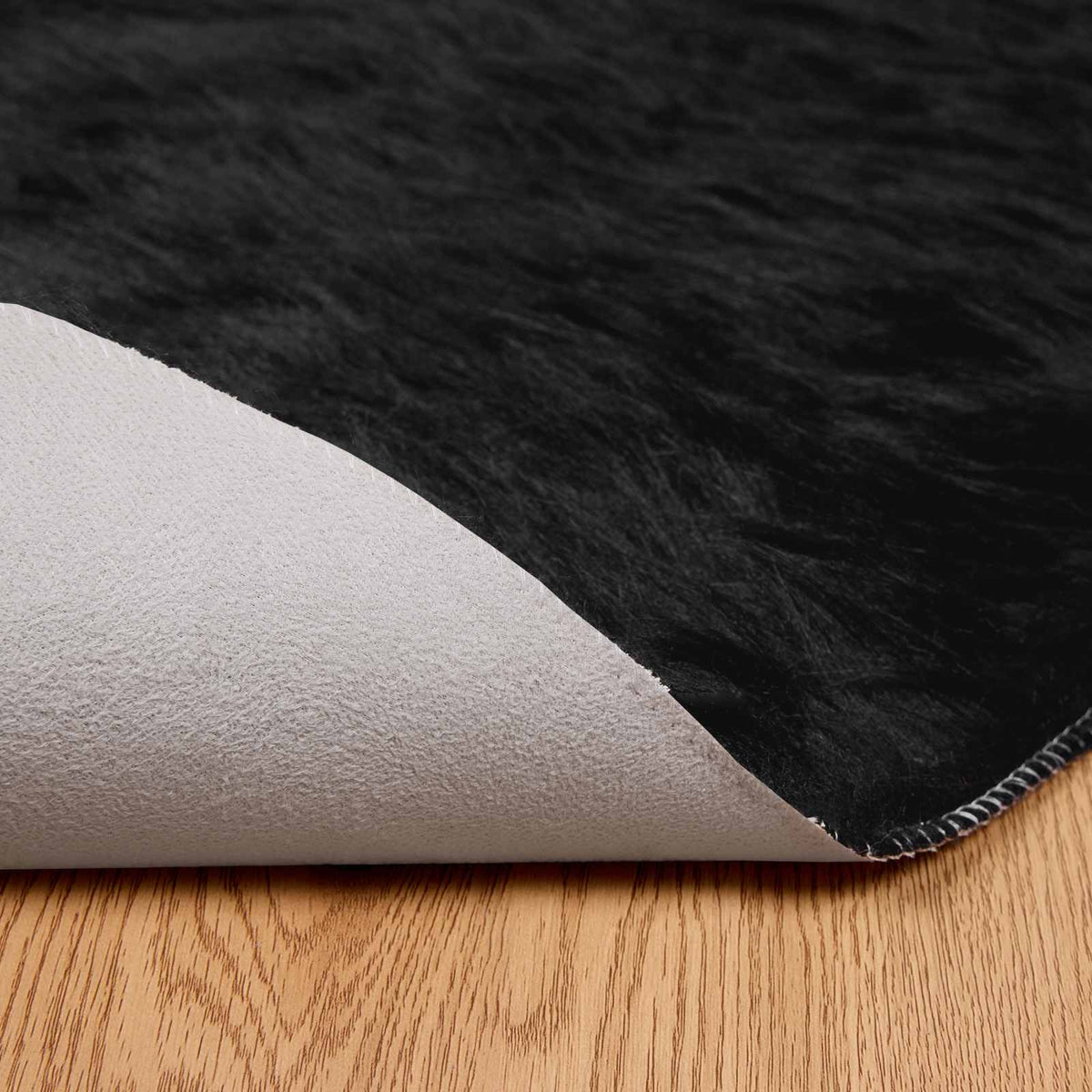 Fuskobbel lammeskindstæppe TAFALLA Sort Ø 100 cm Polyester